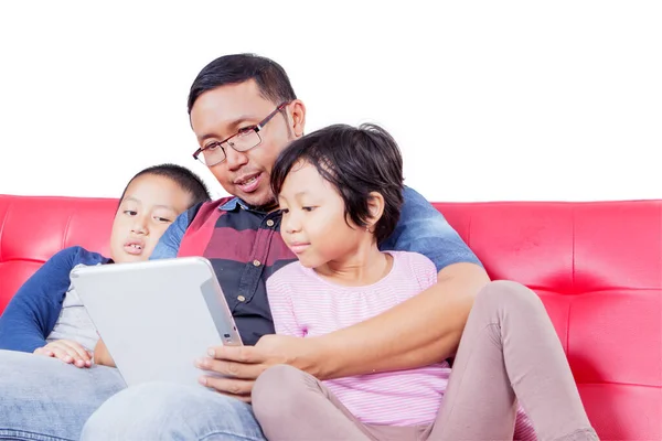 Young Man His Children Using Digital Tablet Together While Sitting — Stok fotoğraf