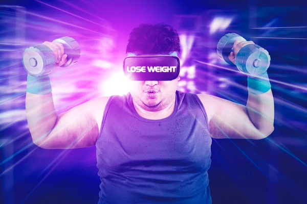 Fat man using a VR glasses with lose weight text while exercising with dumbbells in the cyberspace with virtual screen background