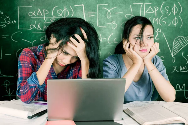 Two Female Student Looks Bored While Studying Together Sitting Doodles — Stockfoto