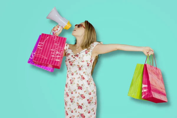 Caucasian Woman Shouting Megaphone While Holding Shopping Bags Standing Studio — Fotografia de Stock