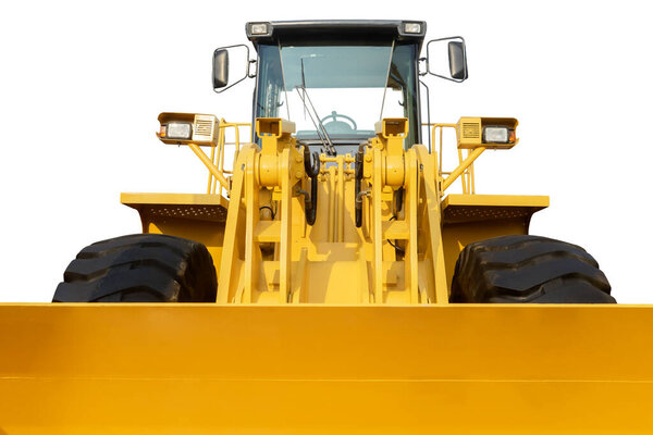 Close up of yellow bulldozer with big scoop in the studio. Isolated on white background