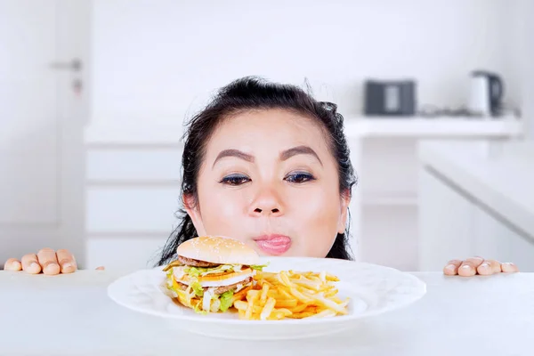 Close Fat Woman Peeking Out Table While Looking Burger French — Stock Photo, Image