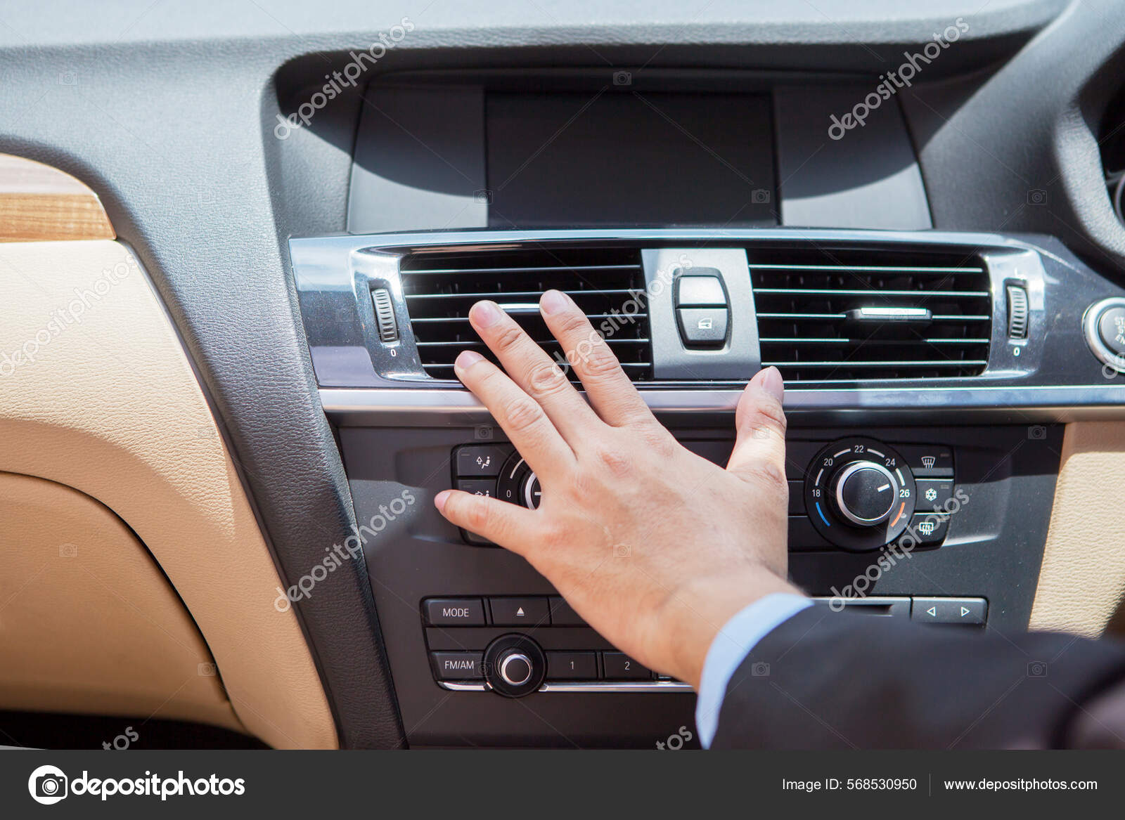 Close Businessman Hand Tuning Air Ventilation Grille While Driving