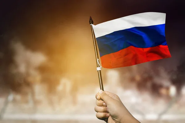 Close Young Man Hand Waving Russia Flag Burned Out City — Stockfoto