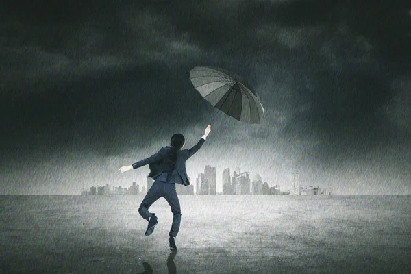 Rear View Businesswoman Holding Umbrella While Jumping City Heavy Rain — Stockfoto