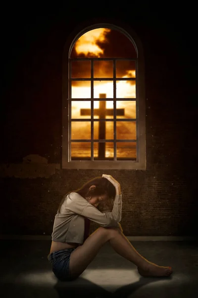 Young Woman Looks Sad While Sitting Silhouette Cross Symbol Window — Φωτογραφία Αρχείου