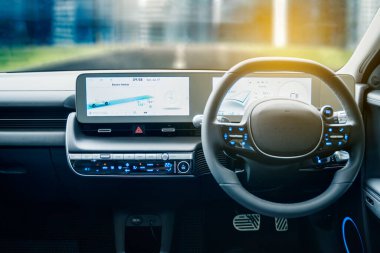 JAKARTA - Indonesia. July 25, 2022: Close up of interior electric car dashboard with GPS navigation device showing the direction