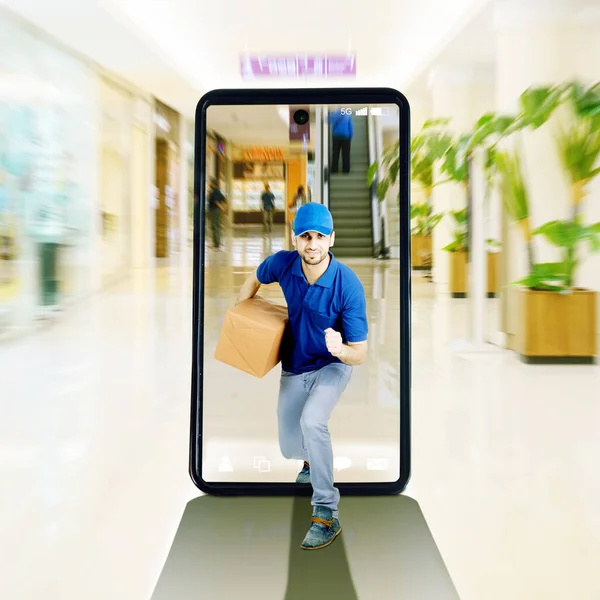 Male Courier Delivering Package While Running Shopping Mall Cellphone Screen — Stock Fotó