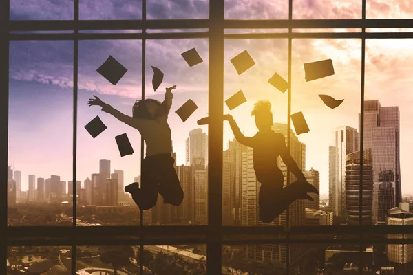 Silhouette Two Business People Jumping Office While Throwing Papers Dusk — Stok fotoğraf