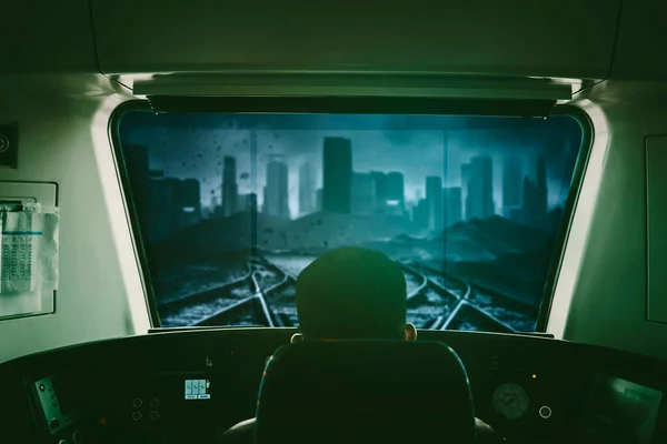 Back view of train driver sitting in cabin while driving a train toward city with cloudy sky background