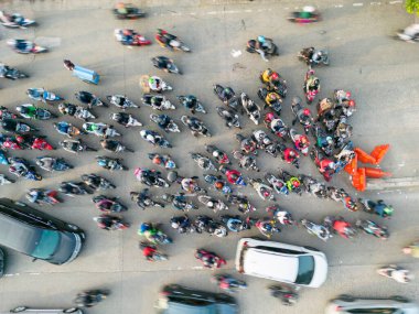 JAKARTA - Indonesia. August 08, 2022: Top down view of chaotic motorcycle and cars moving on the road at the rush hour in Jakarta city