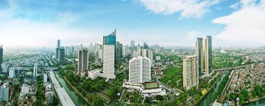 JAKARTA - Indonesia. August 15, 2022: Drone view of Sudirman train station surrounded by urban buildings in Jakarta city at morning time