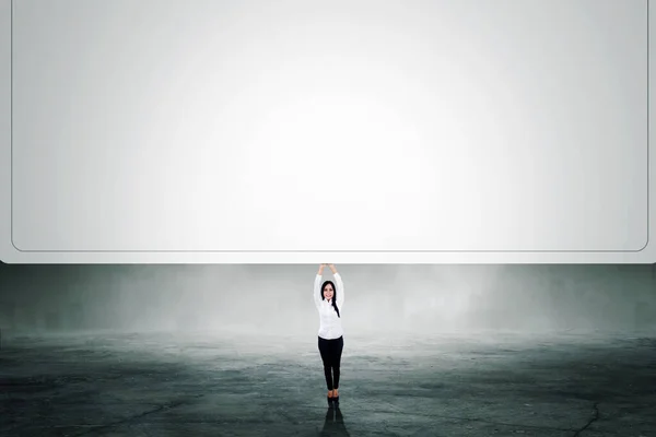 Businesswoman Holding Big Empty Whiteboard While Standing Misty City Background — Stock Photo, Image