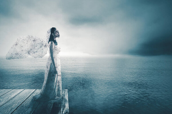 Halloween horror concept. Spooky bride ghost standing on the wooden jetty with misty lake background
