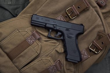 BANGKOK, THAILAND - February 20, 2021 : Glock 17 gen3 model on canvas backpack, Glock is polymer pistol and popular handgun.