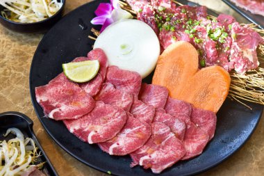 Japanese grilled meat, Beef tongue sliced yakiniku, BBQ korean roast, Asian traditional food.
