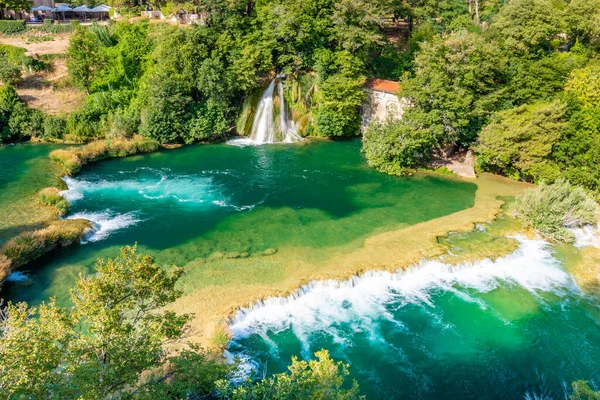 Waterfalls at Krka river, Croatia. Part of the Skradinski Buk waterfall. Famous place in nature park - beautiful tourist destination in Croatia. Fresh green nature, summer weather.