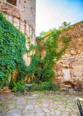 Outdoor view of Pernstejn castle near the Nedvedice village, Czech Republic. Fairytale castle on hill during summer day. Big stone walls and towers.