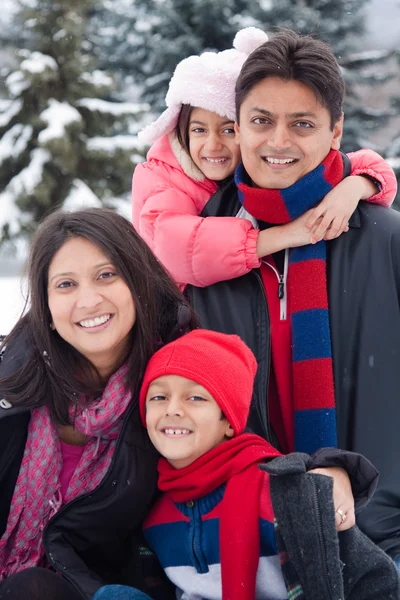 East Indian family playing in the snow — Stock Photo, Image