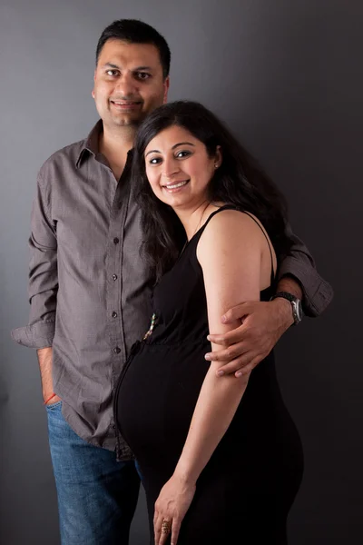 Glad indiska man med sin gravida fru Royaltyfria Stockbilder