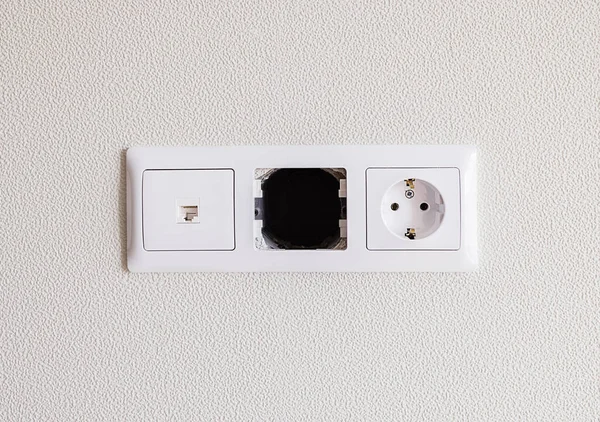 Close-up of an electrical and internet socket with an empty space in the center. — Stock Photo, Image