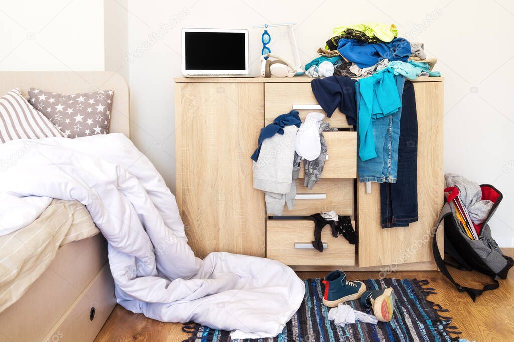 mess in the teenagers room, clothes scattered on the chest of drawers, on the floor, dirty shoes. There is an unmade white blanket on the bed. The concept of transitional age and education