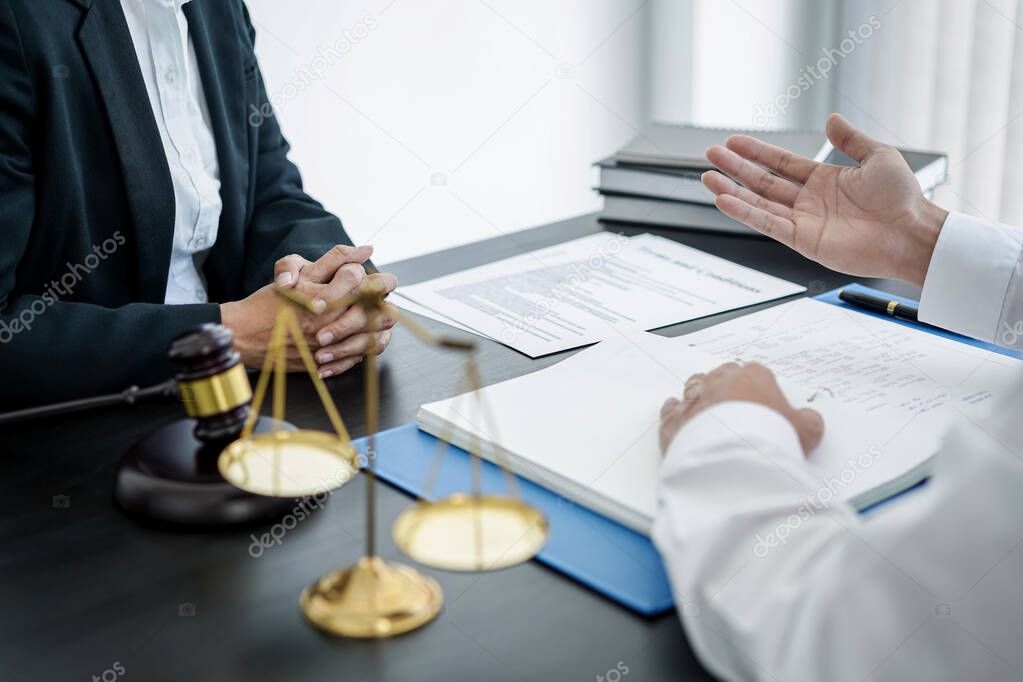 Businessman is bringing the legal document for consultation with female lawyer and she is explaining about legal consultation, terms and condition before signing on contract at law firm