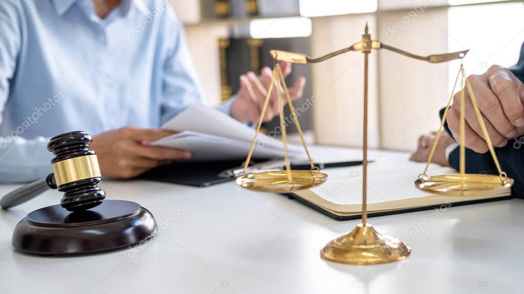 Consultation and conference of professional businesswoman and Male lawyers working and discussion having at law firm in office. Concepts of law, Judge gavel with scales of justice.