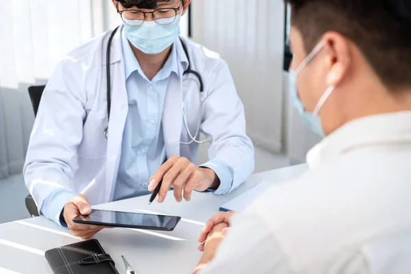 Male Doctor Medical Face Mask Pointing Examination Results Patient Tablet — Stock Photo, Image