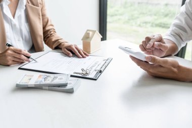 Emlak komisyoncusu görüşmeleri sözleşme formuna ulaşın ve onaylanmış mortgage başvuru formu sigortasıyla anlaşma imzalama kararı için müşteriye danışın..