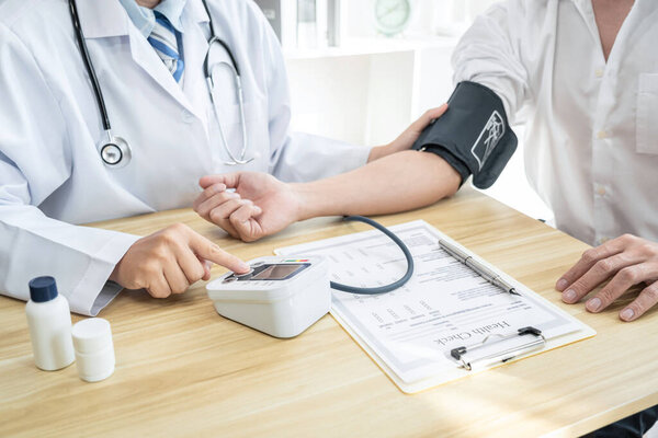 Doctor being measuring examination patient and checking blood pressure to symptom diagnosis illness in hospital clinic.