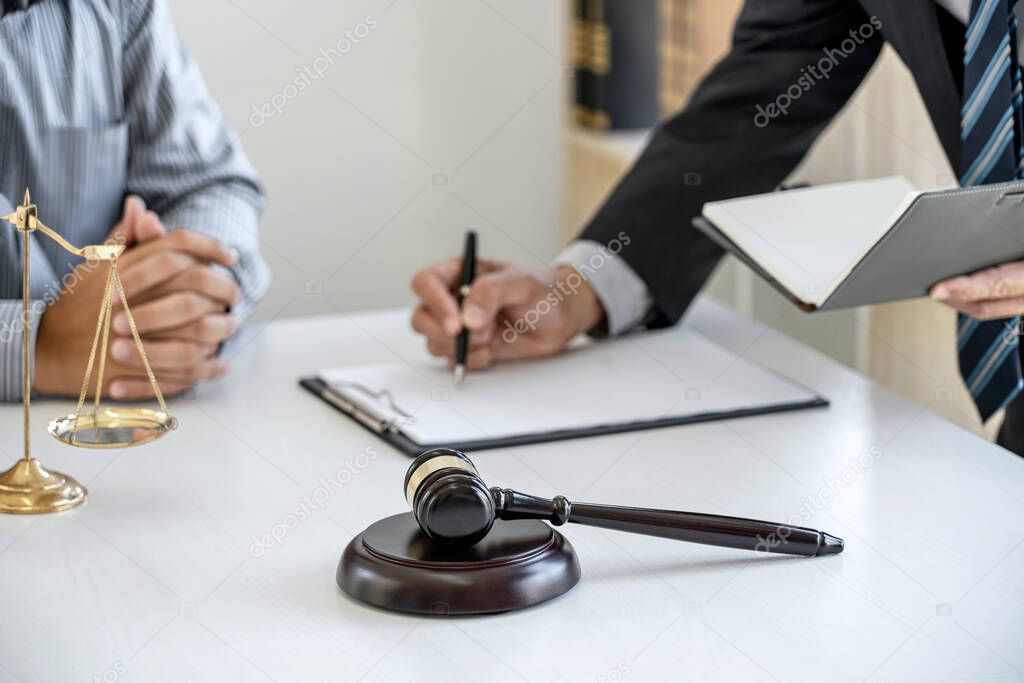 Judge gavel with scales of justice, Businessman and lawyer or counselor consulting and discussing contract papers at law firm in office.