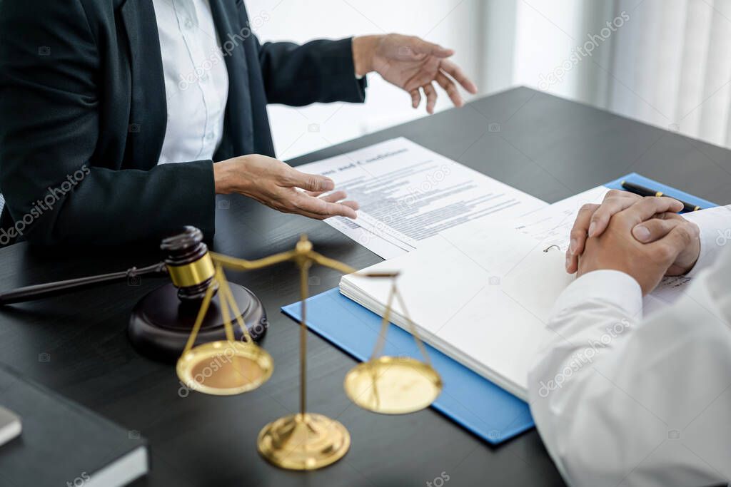 Female lawyer and businessman discussion about terms, condition and legal document agreement for legal consultation before signing on contract at law firm