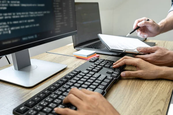 Programmer Team of  Developing programming and website working in a software develop company office, writing codes and typing data code, Programming with HTML, PHP and javascript.