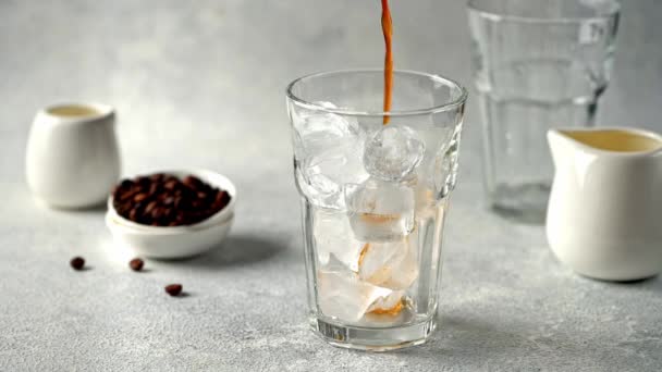 Pouring Cold Brewed Coffee over Ice. Making ice latte. Cold brew with ice and milk. — Stock Video