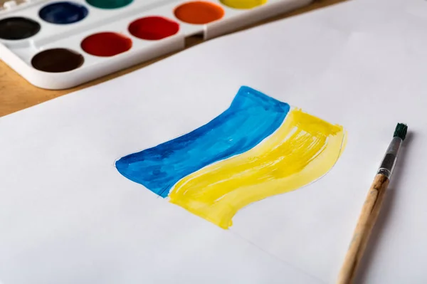 Painting of ukrainian flag. Drawing ukrainian flag. Stop war concept. Patriotic concept. War in Ukraine.