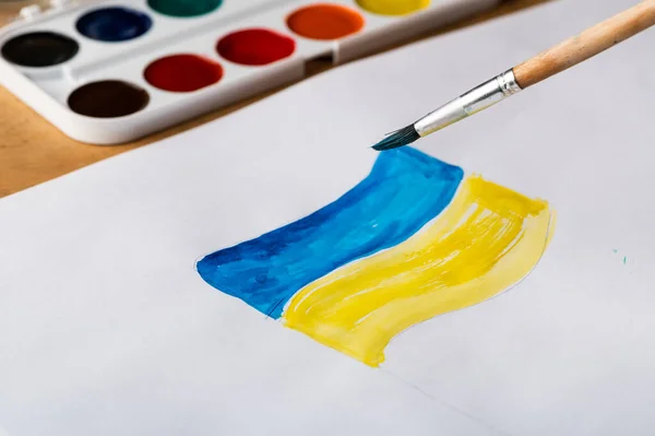 Painting of ukrainian flag. Drawing ukrainian flag. Stop war concept. Patriotic concept. War in Ukraine.