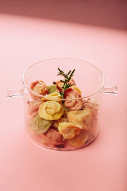 Pembe arka planda şeffaf bir tencerede hamur tatlısı. Yüksek kalite fotoğraf