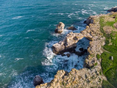 Aerial top view of sea waves and fantastic cliffs, rocky coast. Tyulenovo, Bulgaria