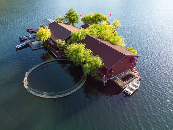Aerial top view of a floating house in Vacha Dam, Devin Municipality, Bulgaria