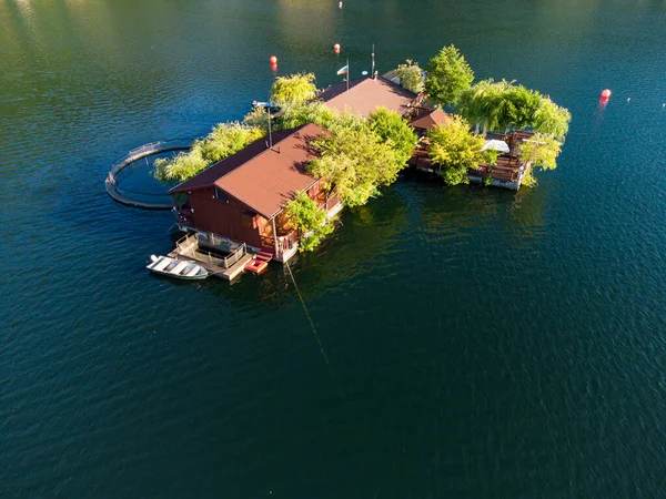Aerial top view of a floating house in Vacha Dam, Devin Municipality, Bulgaria