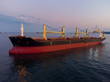 Large general cargo ship tanker bulk carrier, aerial top view at night.