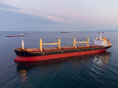 Large general cargo ship tanker bulk carrier, aerial top view at night.