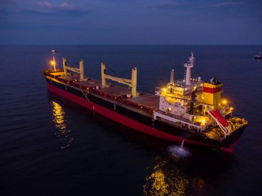 Large general cargo ship tanker bulk carrier, aerial top view at night.