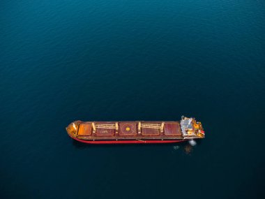 Large general cargo ship tanker bulk carrier, aerial top view at night.