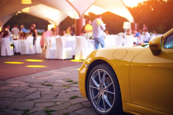 Parked Yellow Luxury Car Celebrating People Blurred Background — Stok fotoğraf