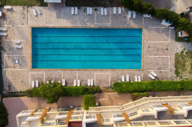 Aerial top view of beautiful luxury outdoor swimming pool in hotel resort