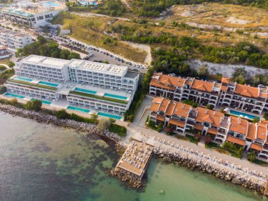 Aerial top view of beautiful luxury outdoor swimming pool in hotel resort near the sea