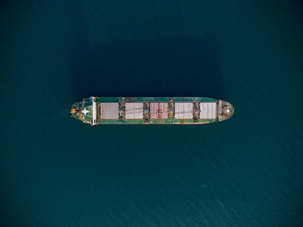 large bulk carrier transports grain at sea, aerial top view