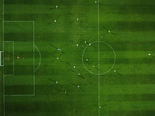 Aerial view of a football match, soccer. Football field and Footballers from drone top down view